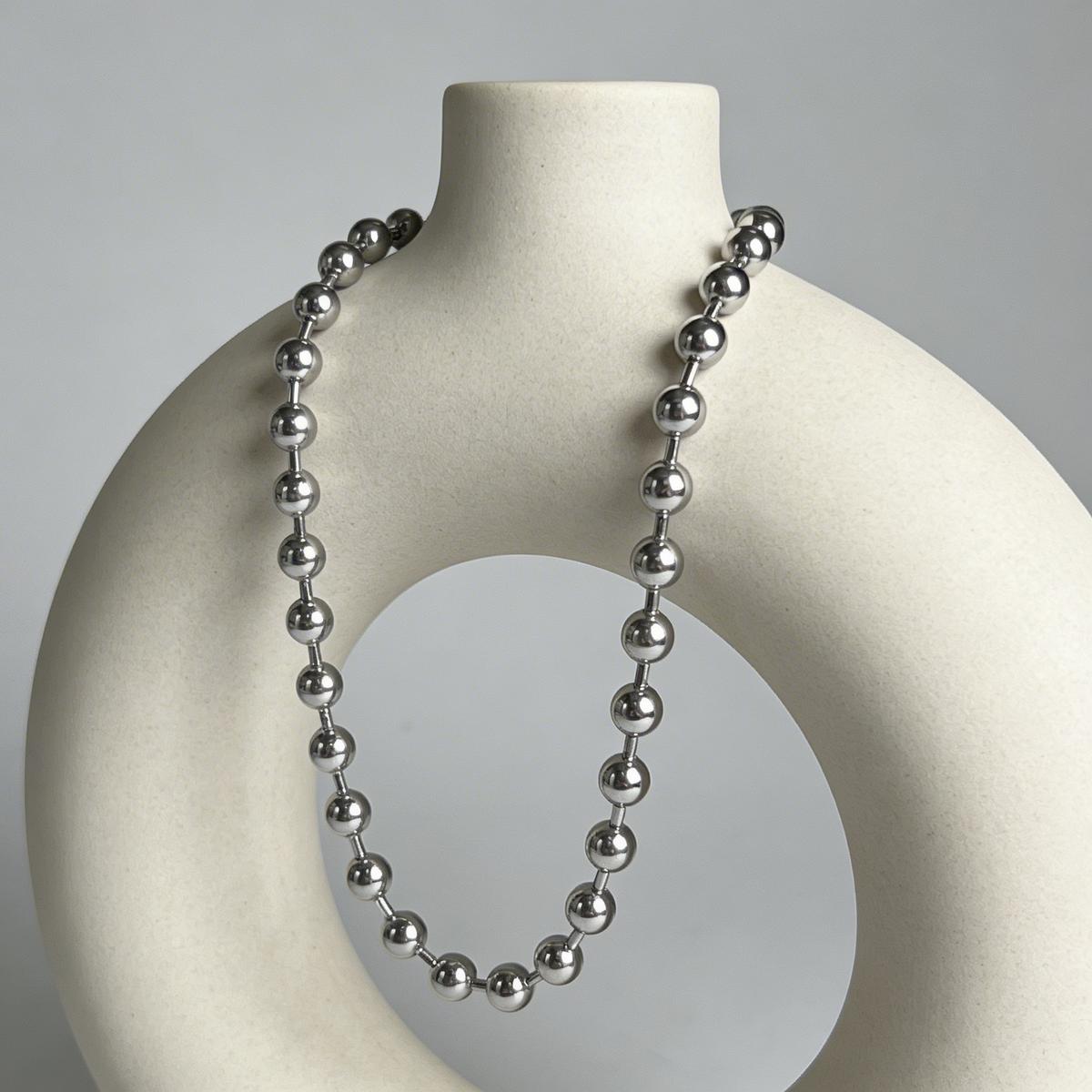 Elegant necklace on marble surface with soft studio lighting